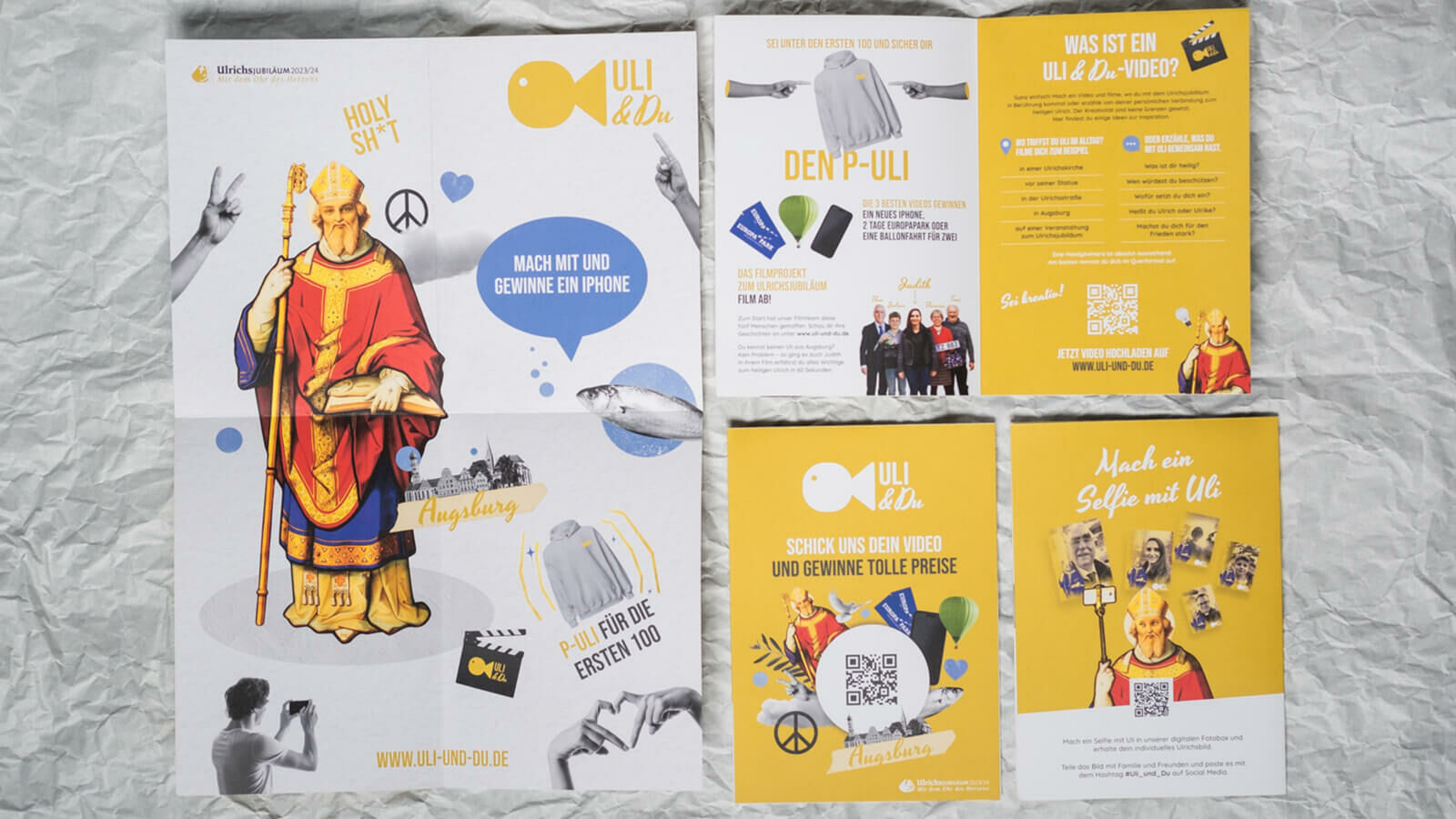 Poster und Flyer von Uli & Du mit der Illustration des heiligen Ulrich und der Zeile „Holy Sh*t“.
